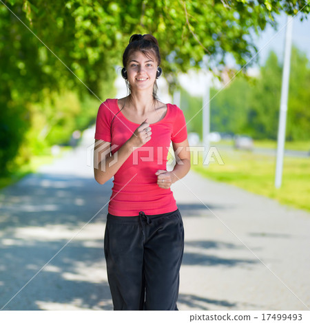 Runner - woman running outdoors in green park 17499493