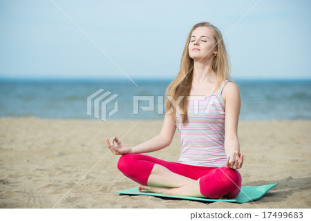 Young lady practicing yoga. Workout near ocean sea coast. Young lady practicing yoga. Workout near ocean sea coast. 17499683
