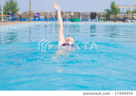 Woman in goggles swimming back crawl style Woman in goggles swimming back crawl style 17499954