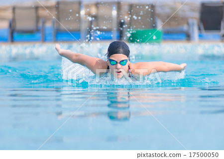 Young girl swimming butterfly stroke style 17500050