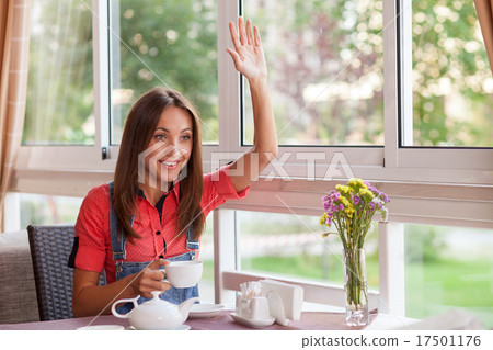 Cheerful young girl has meeting in cafe Cheerful young girl has meeting in cafe 17501176