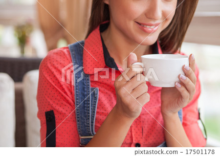 Cheerful young hipster girl is resting in cafe Cheerful young hipster girl is resting in cafe 17501178
