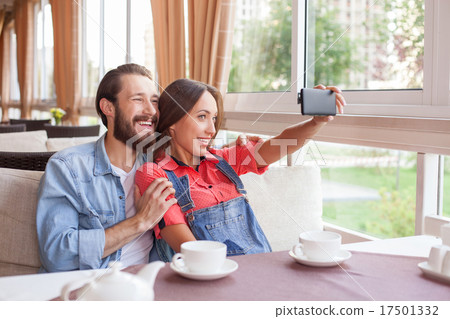 Cheerful young man and woman are making selfie in Cheerful young man and woman are making selfie in 17501332
