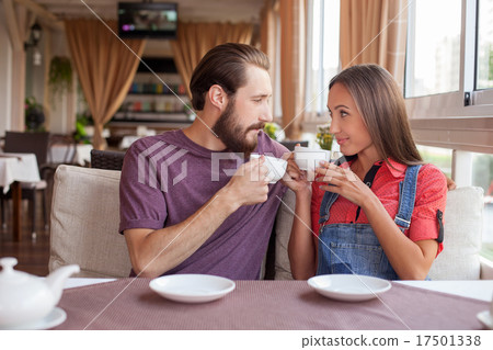 Beautiful young loving couple is dating in cafe Beautiful young loving couple is dating in cafe 17501338