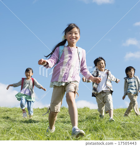Elementary school student running on the meadow 17505443