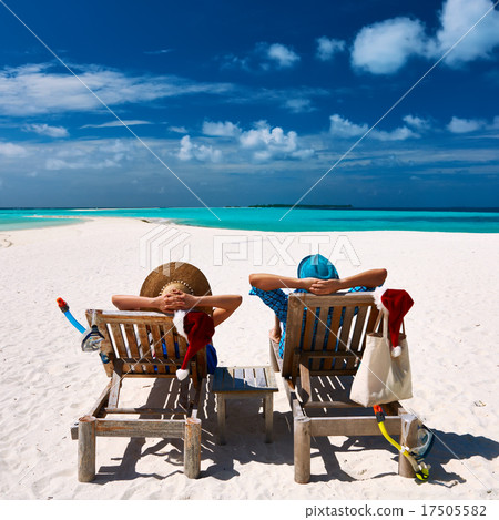 Couple relax on a beach at christmas Couple relax on a beach at christmas 17505582