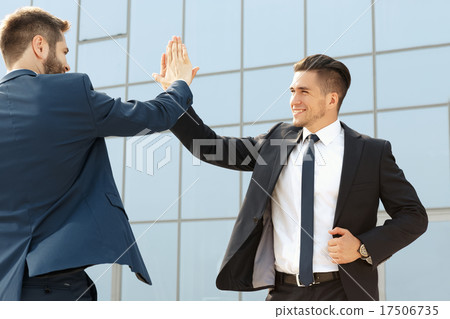 Two  business colleagues high-fiving 17506735