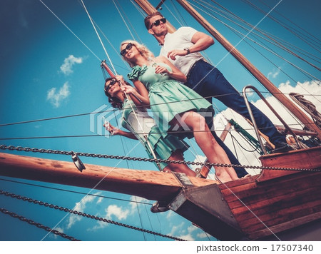 Stylish wealthy friends having fun on a luxury yacht Stylish wealthy friends having fun on a luxury yacht 17507340