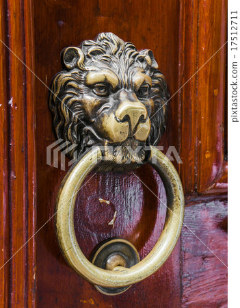 Old wooden door decorated with a lion head 17512711