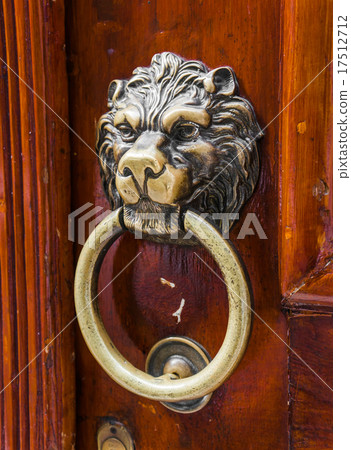 Old wooden door decorated with a lion head 17512712