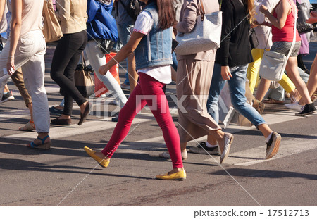 feet of the pedestrians crossing on city street feet of the pedestrians crossing on city street 17512713