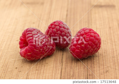 Ripe sweet raspberries on wood table close-up Ripe sweet raspberries on wood table close-up 17513648