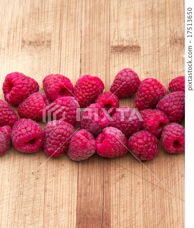 Ripe sweet raspberries on wood table close-up Ripe sweet raspberries on wood table close-up 17513650