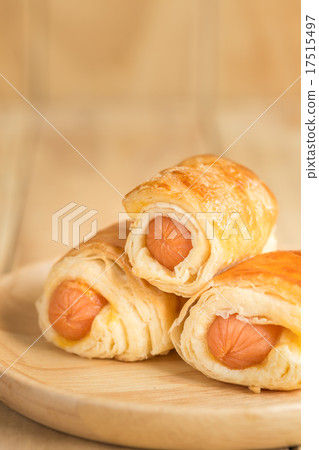 Danish Pastry with sausage on wooden dish Danish Pastry with sausage on wooden dish 17515497