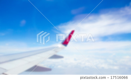 Abstract blur Wing of an airplane flying above the clouds 17516066