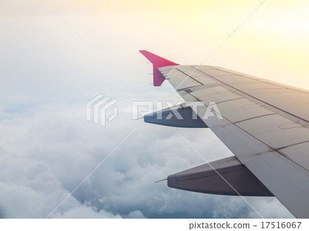 Wing of an airplane flying above the clouds Wing of an airplane flying above the clouds 17516067