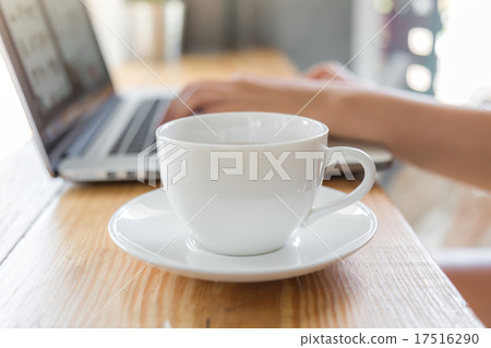 Coffee cup with laptop on old wooden table Coffee cup with laptop on old wooden table 17516290