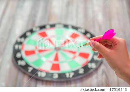 Hand holdin red arrow and throwing to dart board Hand holdin red arrow and throwing to dart board 17516343