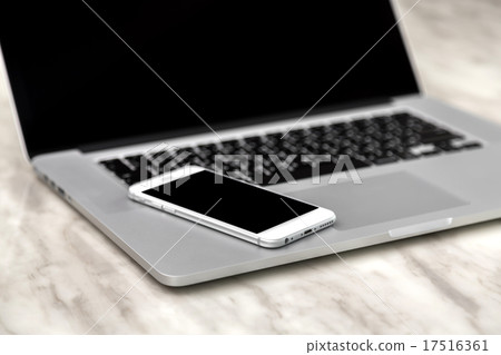 laptop with smart phone on table laptop with smart phone on table 17516361