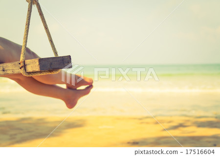 Woman leg on a swing at tropical sea beach 17516604