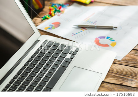 Financial charts on the table with laptop Financial charts on the table with laptop 17516698