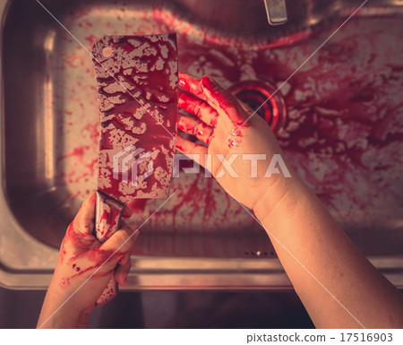 Hand hold bloody knife in a steel shell for halloween ( Filtered 17516903