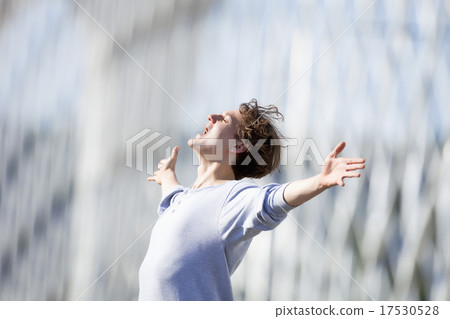 Excited Young Man Stretching out his Arm in Emotion Excited Young Man Stretching out his Arm in Emotion 17530528