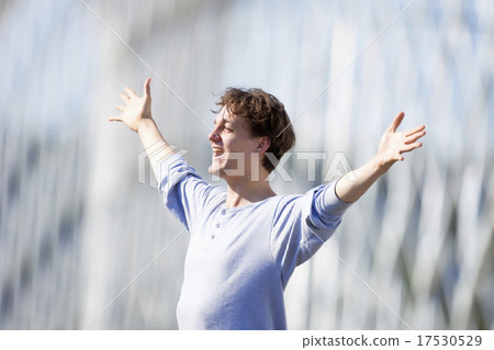 Excited Young Man Stretching out his Arm in Emotion 17530529