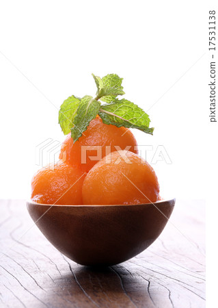 Cantaloupe melon in wooden spoon on wooden table 17531138