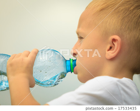Child drinking pure water from plastic bottle Child drinking pure water from plastic bottle 17533435