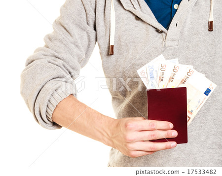 Tourist holding passport full of money. Tourist holding passport full of money. 17533482