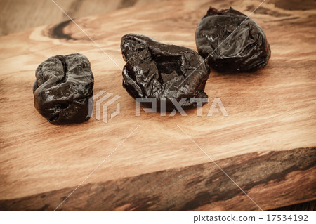 dried plums prunes on wooden table dried plums prunes on wooden table 17534192