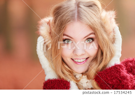 Portrait of pretty smiling woman in earmuffs. Portrait of pretty smiling woman in earmuffs. 17534245