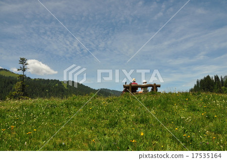 A couple taking a break while hiking A couple taking a break while hiking 17535164