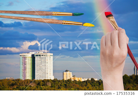 brush paints rainbow in blue clouds over houses brush paints rainbow in blue clouds over houses 17535316