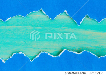 Torn  paper with a blue wooden background 17535935