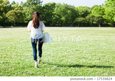A woman walking in the park A woman walking in the park 17539824