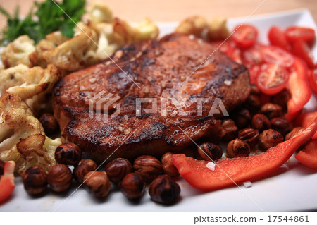 grilled meat cooked with nuts and vegetables serving 17544861
