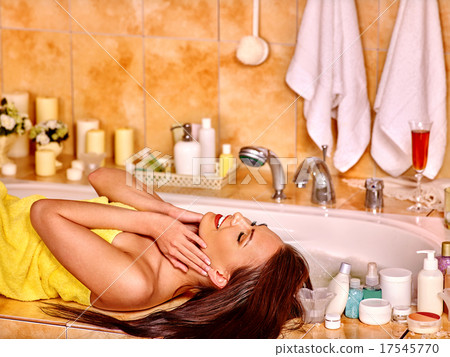 Woman applying moisturizer. 17545770