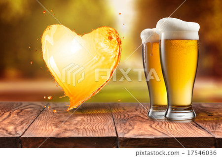 Love beer. Beer in glass with heart splash on wood Love beer. Beer in glass with heart splash on wood 17546036