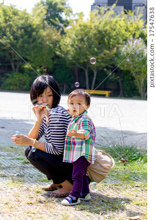Parents playing soap bubbles Parents playing soap bubbles 17547638
