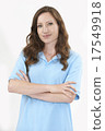 Studio Portrait Of Female Staff Member Wearing Uniform Against W 17549918