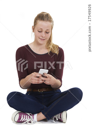 Studio Shot Of Teenage Girl Sending Text Message Studio Shot Of Teenage Girl Sending Text Message 17549926
