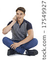 Studio Portrait Of Teenage Boy Talking On Mobile Phone 17549927