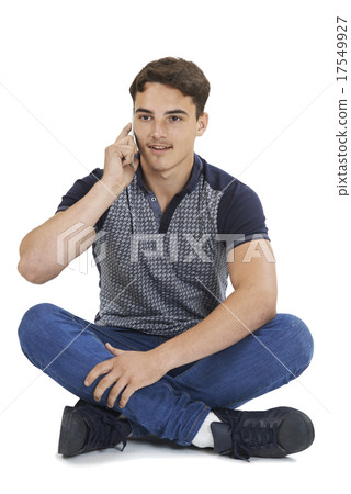 Studio Portrait Of Teenage Boy Talking On Mobile Phone Studio Portrait Of Teenage Boy Talking On Mobile Phone 17549927