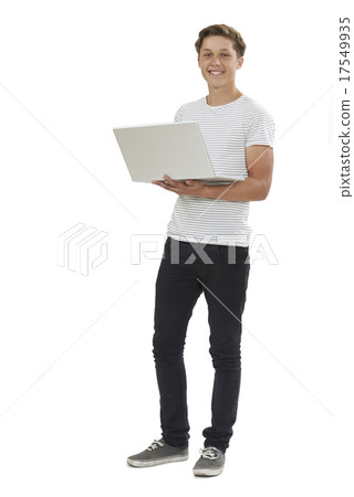 Full Length Studio Shot Of Teenage Boy Using Laptop Full Length Studio Shot Of Teenage Boy Using Laptop 17549935