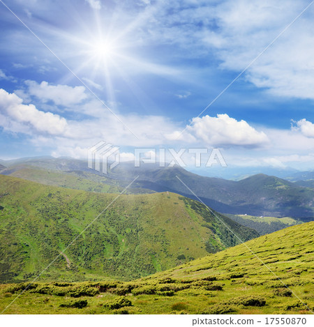 High mountains and sun on blue sky High mountains and sun on blue sky 17550870