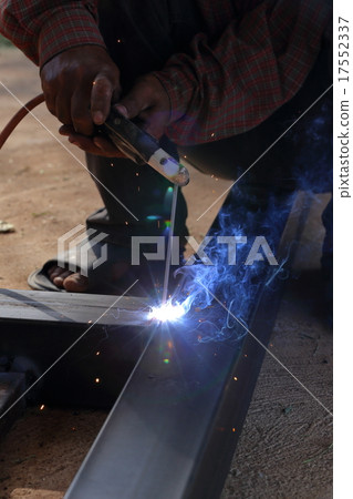 hand of worker welding metal 17552337