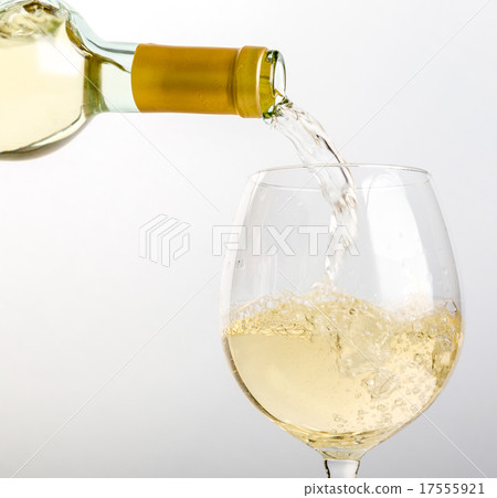 White wine pouring in glass from a bottle White wine pouring in glass from a bottle 17555921