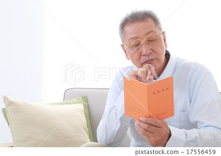 Senior men watching the pension book Senior men watching the pension book 17556459